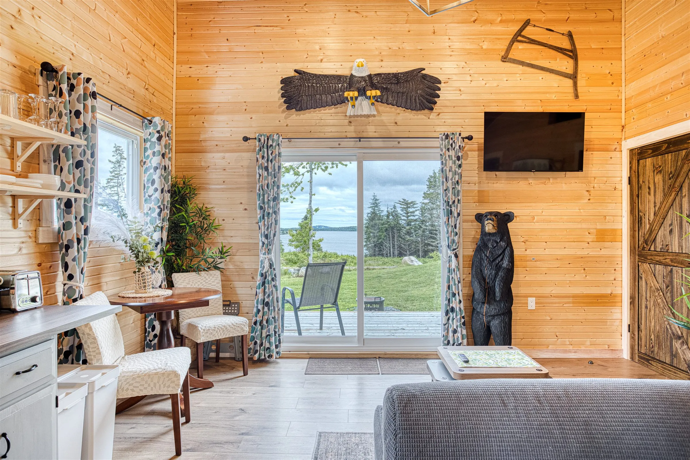 Living room sliding doors framing a view over the deck to Chezzetcook Inlet.