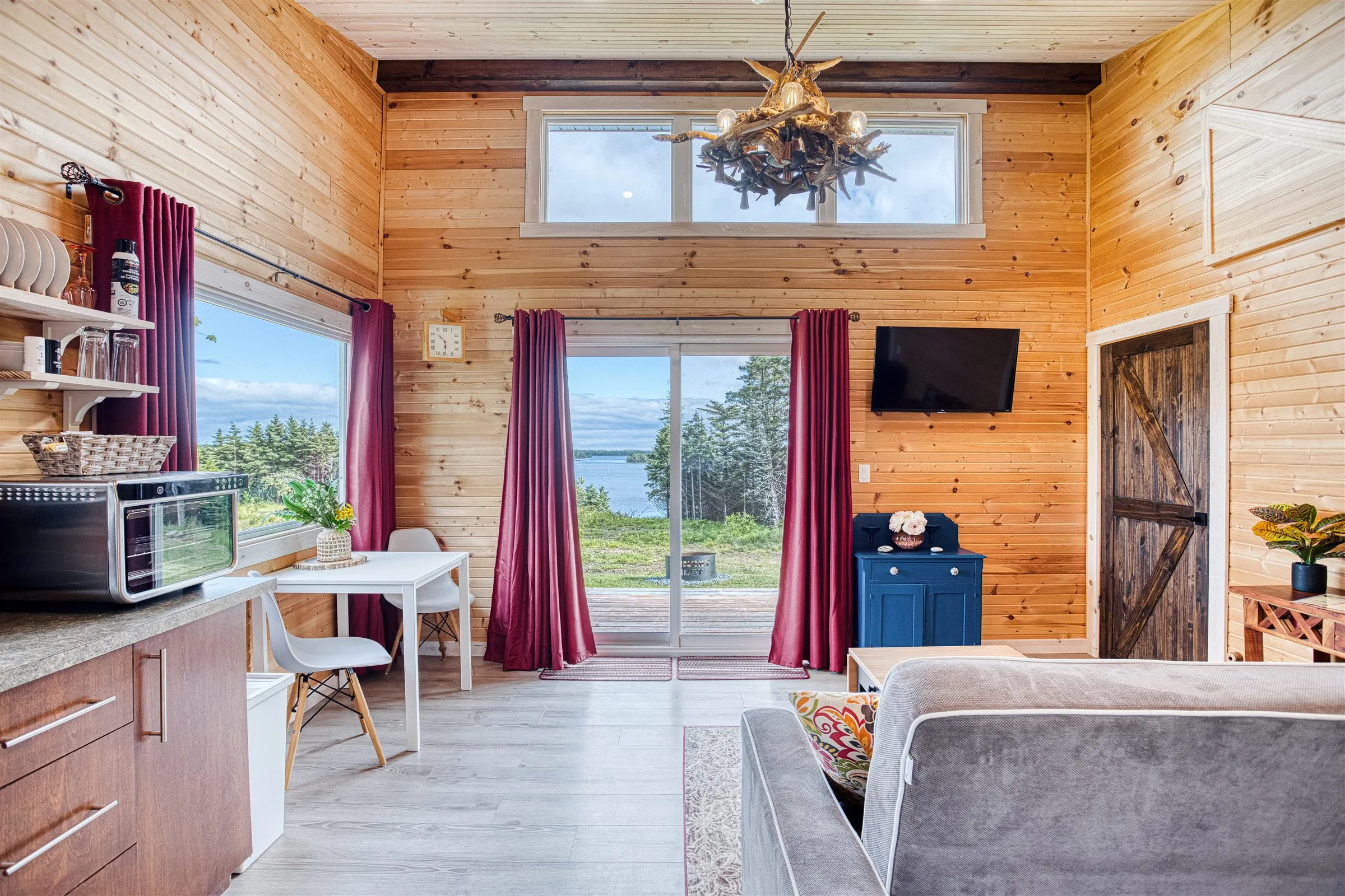 Living room with sliding glass doors framing a view of Chezzetcook Inlet.