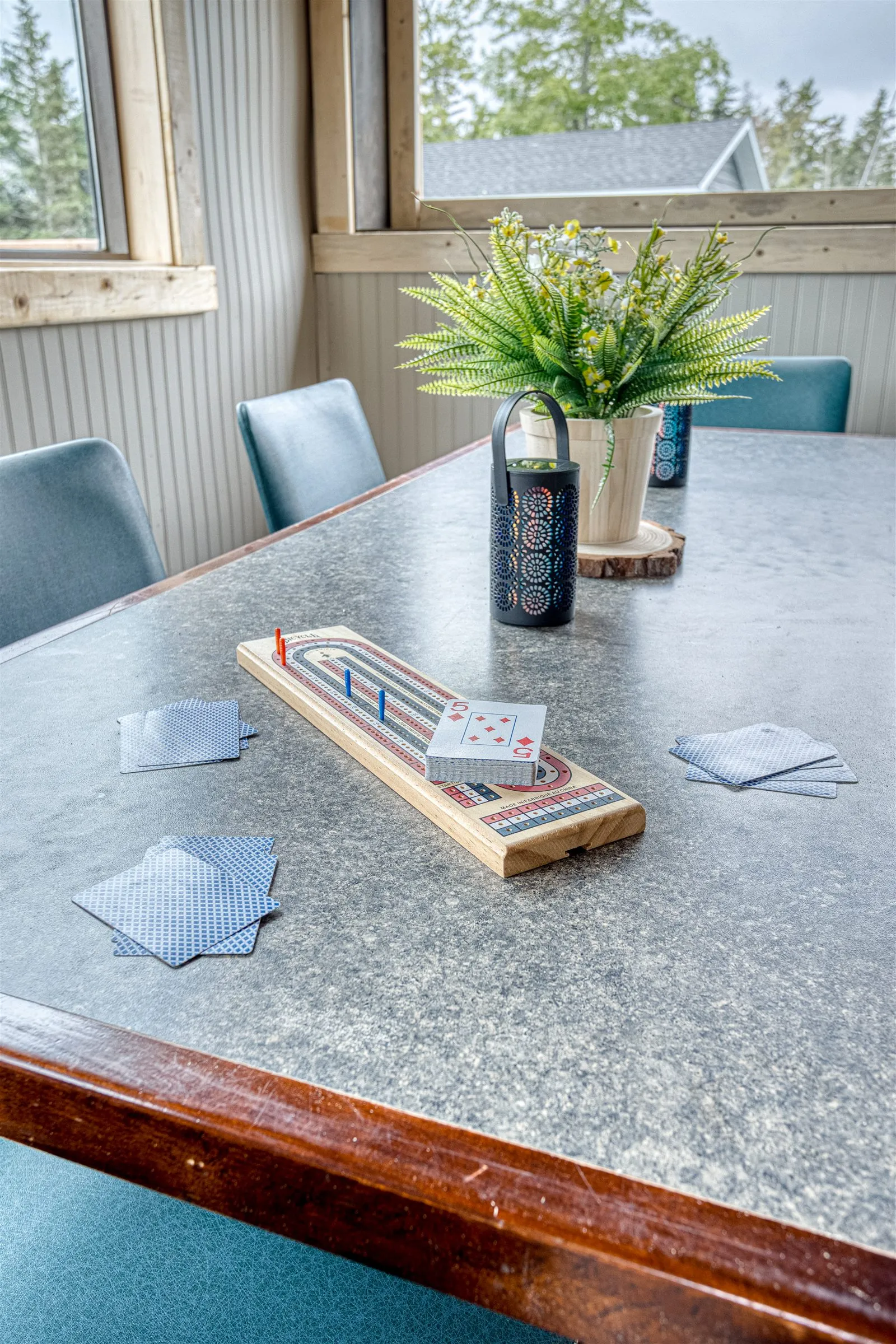 Cribbage board and playing cards set out on a shared table.