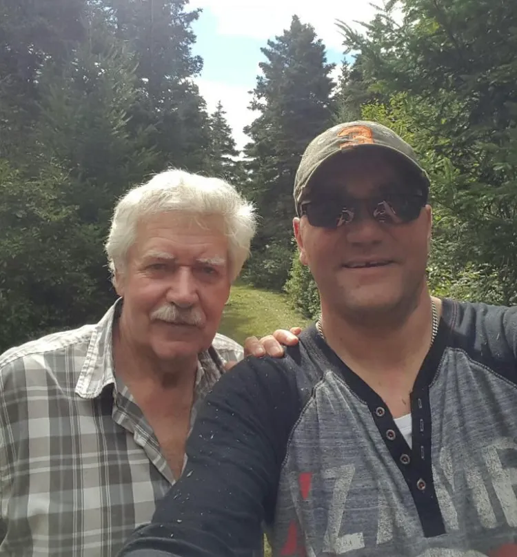 Kyle and his dad Tom together on the green path up the hill.