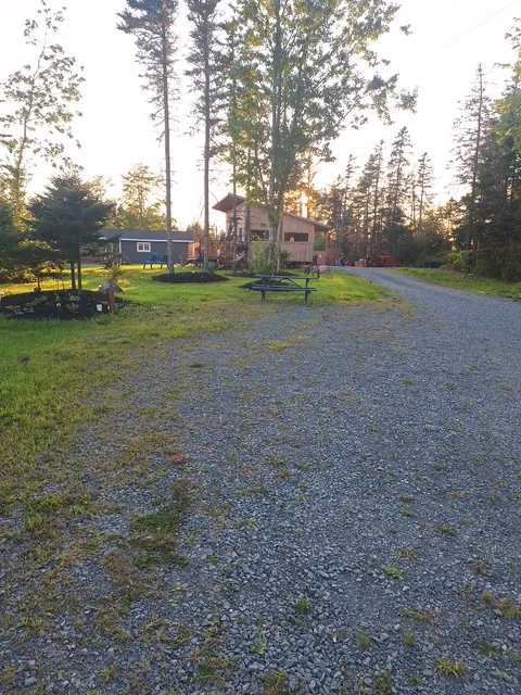 The gravel pad at Site 03 beside the Clubhouse lawn and play area.